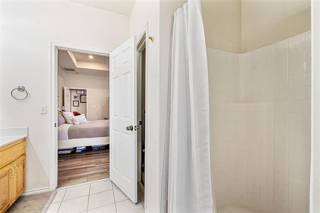 bathroom with tile patterned flooring, vanity, and curtained shower