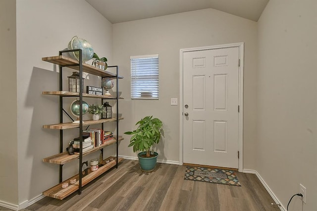 entrance foyer with wood-type flooring and lofted ceiling