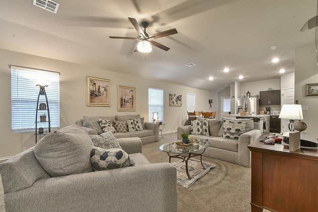 living room with light colored carpet, ceiling fan, and lofted ceiling