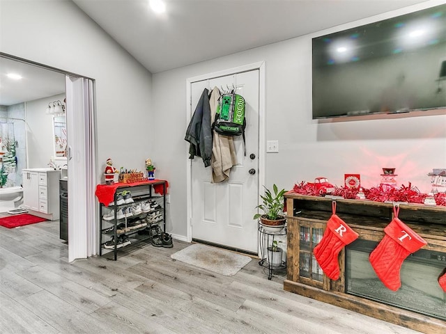 entryway with light hardwood / wood-style flooring and lofted ceiling