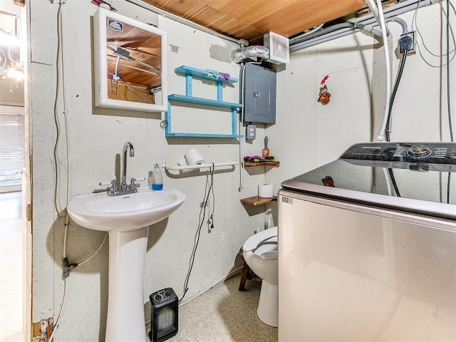 washroom with electric panel, sink, wooden ceiling, and washer / dryer