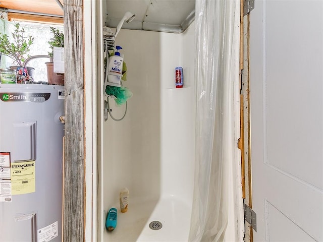 bathroom featuring electric water heater and curtained shower