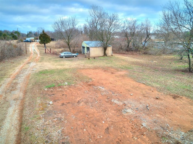 view of yard with a rural view and a shed