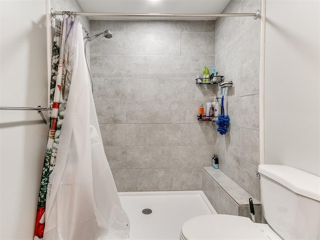 bathroom with a shower with curtain and toilet