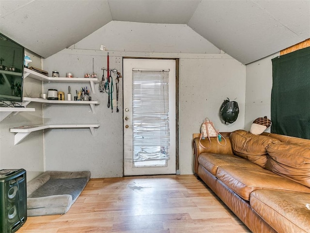 living room featuring light hardwood / wood-style floors and vaulted ceiling