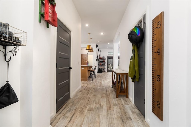 hallway with light hardwood / wood-style floors