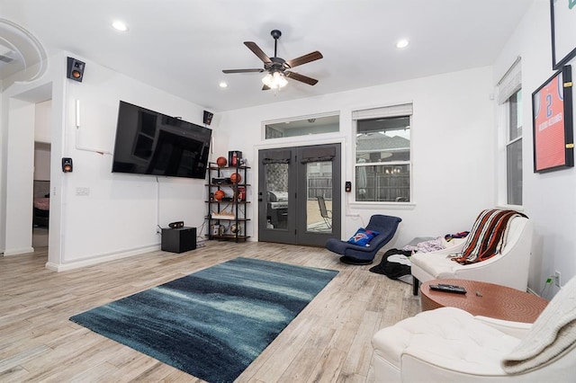 living room featuring wood-type flooring and ceiling fan