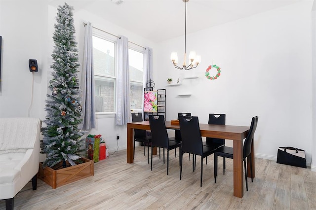 dining room featuring a chandelier and light hardwood / wood-style floors