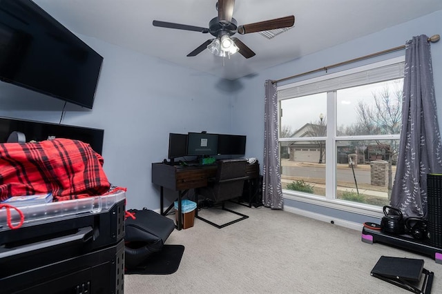 carpeted office space with ceiling fan