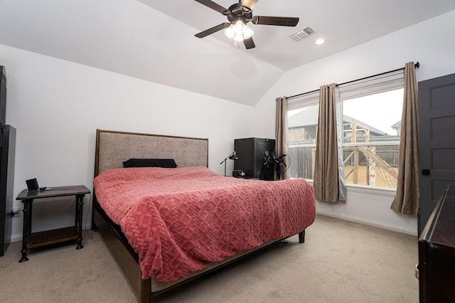 carpeted bedroom with ceiling fan and vaulted ceiling