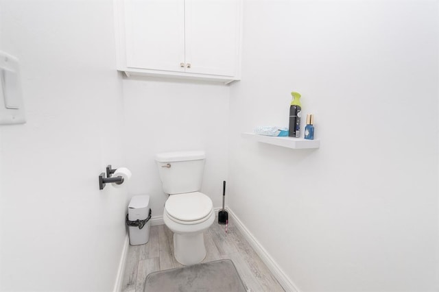 bathroom featuring hardwood / wood-style floors and toilet