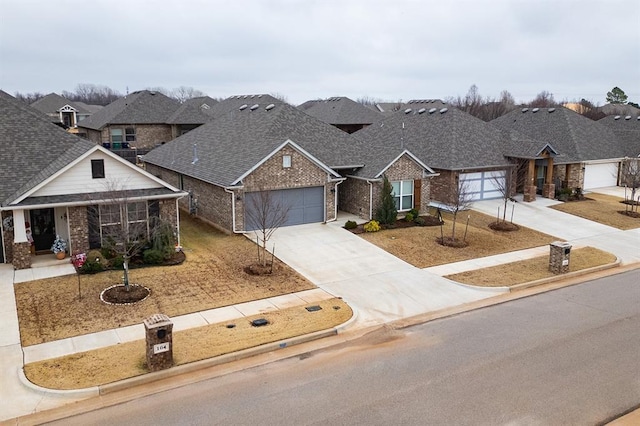 24 Carat Dr, Yukon, OK 73099 - view of front of property featuring concrete driveway, a garage, brick siding, a residential view, and a shingled roof
