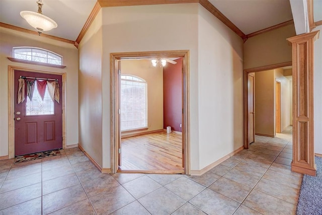 tiled foyer entrance featuring ornamental molding