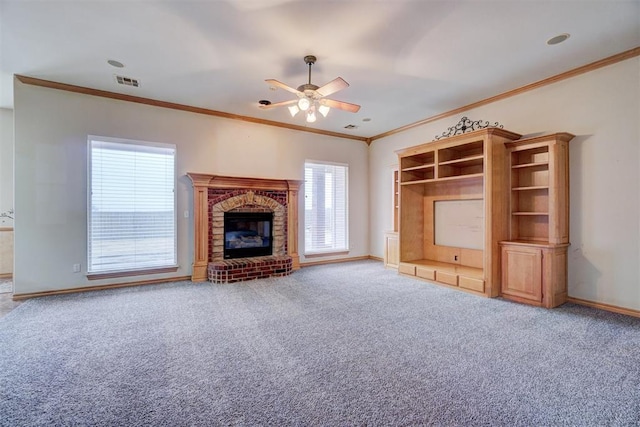 unfurnished living room with ceiling fan, crown molding, carpet floors, and a fireplace