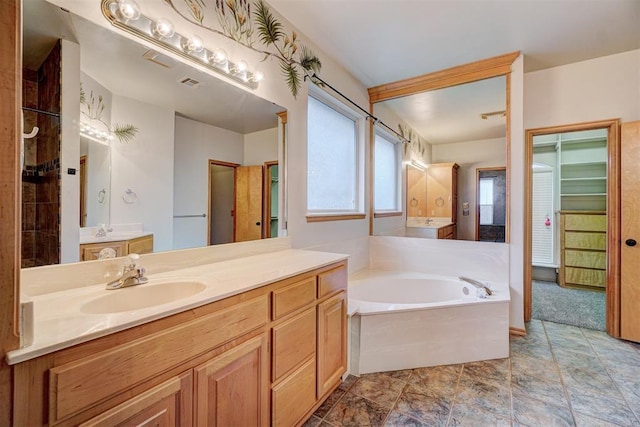 bathroom with vanity and a tub to relax in