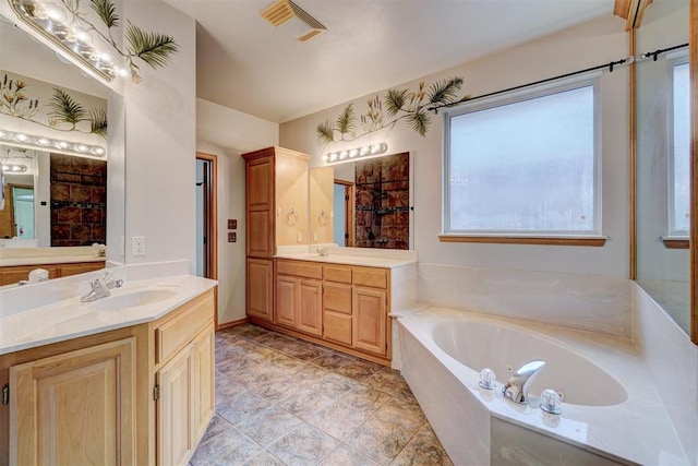 bathroom with vanity and a relaxing tiled tub