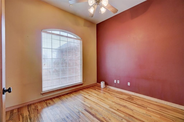 empty room with ceiling fan and light wood-type flooring