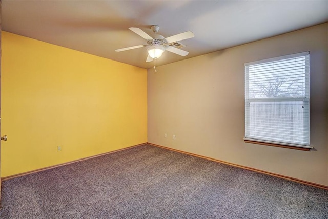 carpeted spare room featuring ceiling fan