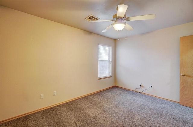 carpeted spare room featuring ceiling fan