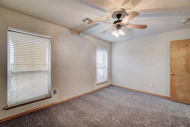 empty room with ceiling fan and carpet floors