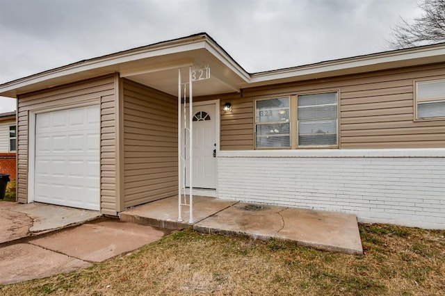 doorway to property with a garage