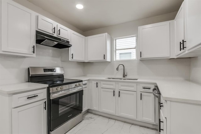 kitchen with sink, white cabinets, appliances with stainless steel finishes, and tasteful backsplash