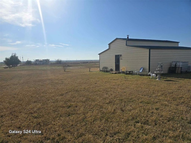 view of side of property with a yard