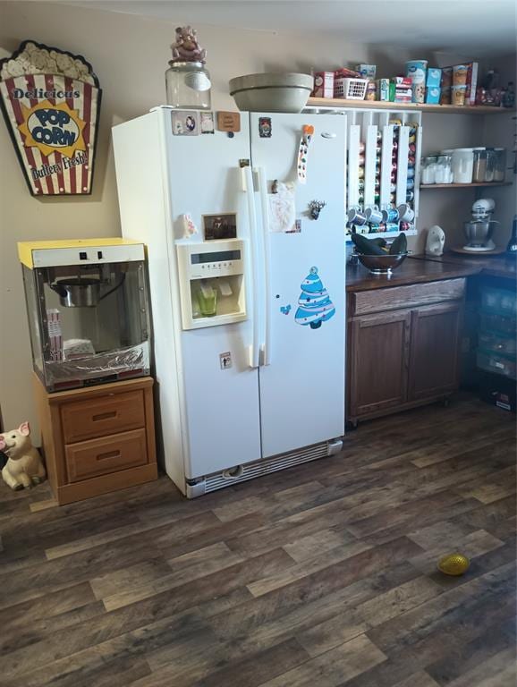 kitchen with dark hardwood / wood-style flooring and white refrigerator with ice dispenser