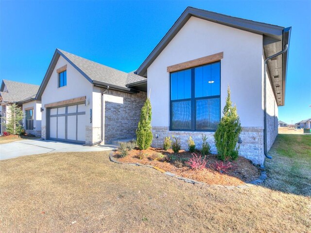 view of front of property with a front yard and a garage