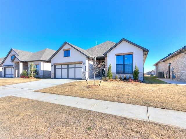 view of front of house with a garage and central AC unit