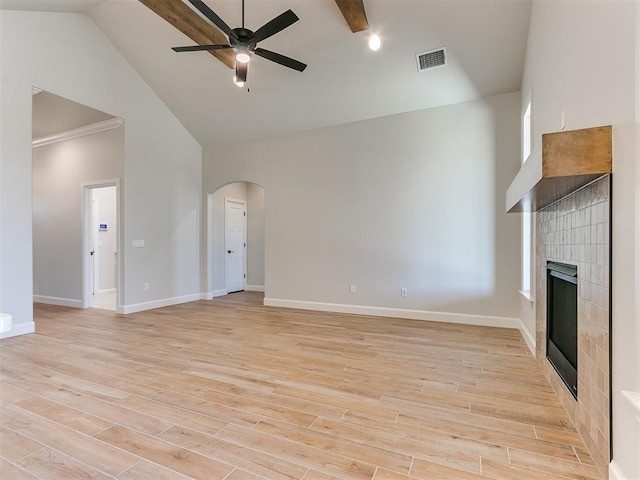 unfurnished living room with ceiling fan, light hardwood / wood-style flooring, high vaulted ceiling, a fireplace, and ornamental molding