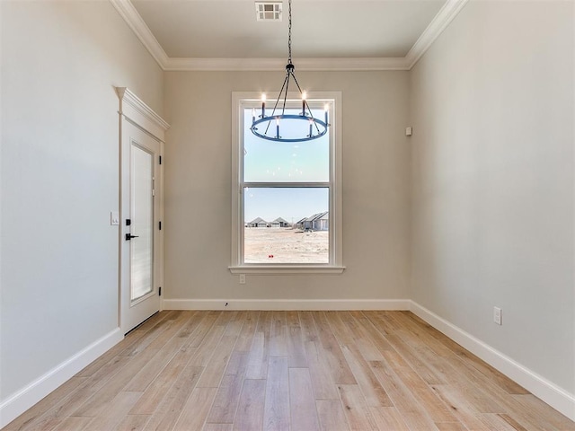 interior space with light hardwood / wood-style flooring and crown molding