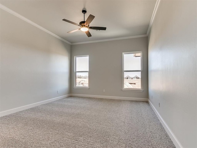 empty room featuring carpet flooring, ceiling fan, and crown molding