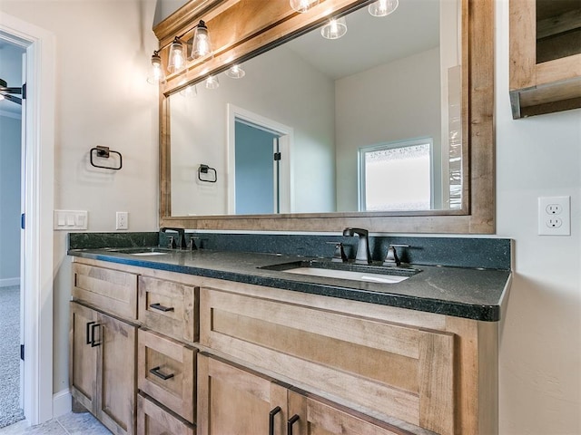 bathroom featuring tile patterned flooring, vanity, and ceiling fan