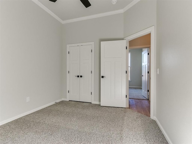 unfurnished bedroom featuring carpet flooring, a closet, ornamental molding, and ceiling fan