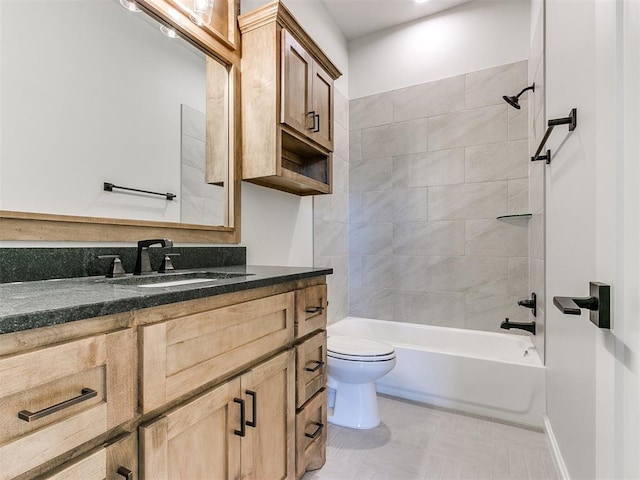 full bathroom featuring vanity, tiled shower / bath combo, and toilet
