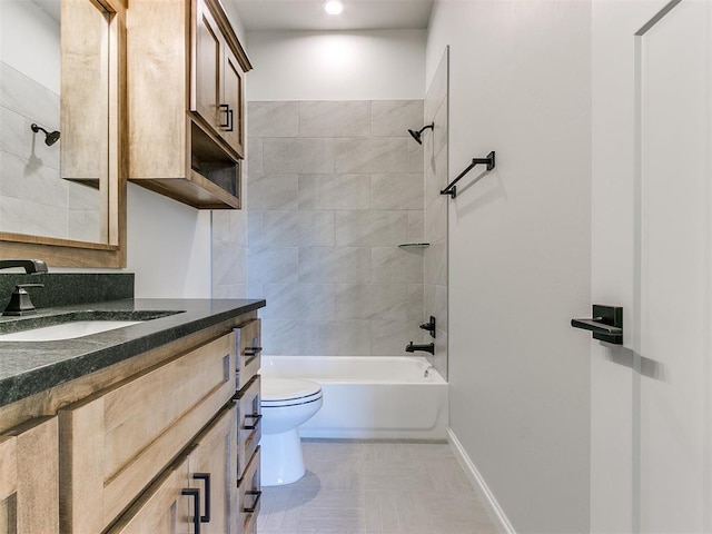 full bathroom featuring vanity, tiled shower / bath combo, and toilet