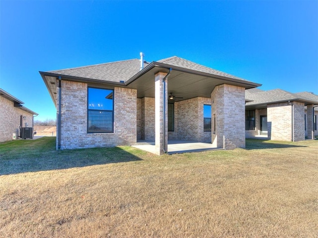 back of house featuring a lawn, a patio area, ceiling fan, and cooling unit