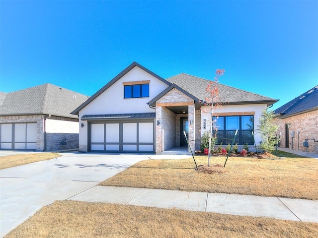 view of front of home with a front yard and a garage