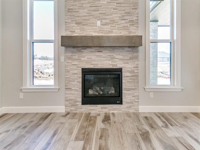 room details with wood-type flooring and a tiled fireplace