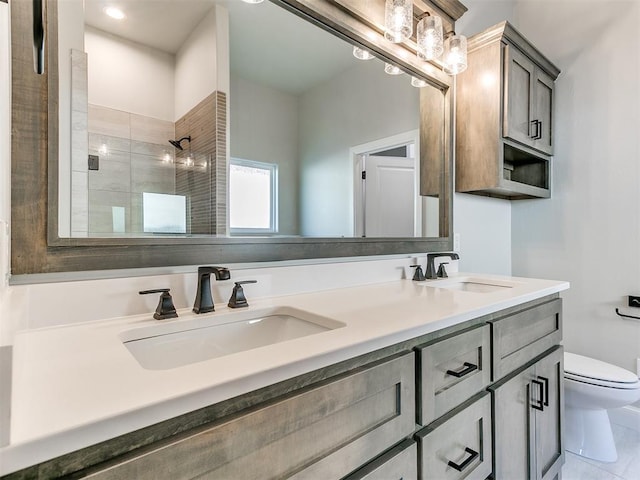 bathroom featuring vanity, toilet, and an enclosed shower