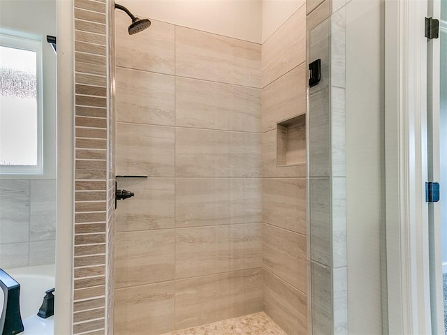 bathroom with tiled shower