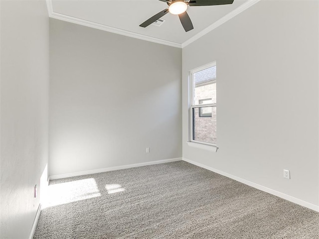 carpeted spare room featuring ceiling fan and ornamental molding