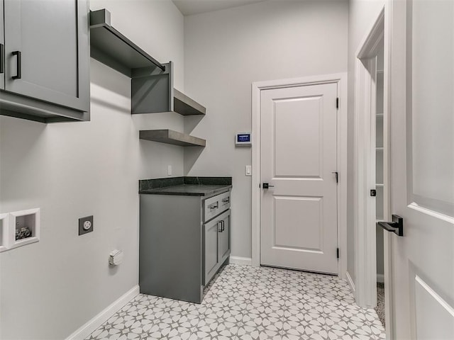 clothes washing area with hookup for an electric dryer, cabinets, and washer hookup