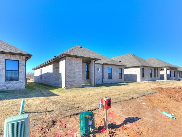 rear view of house featuring a yard