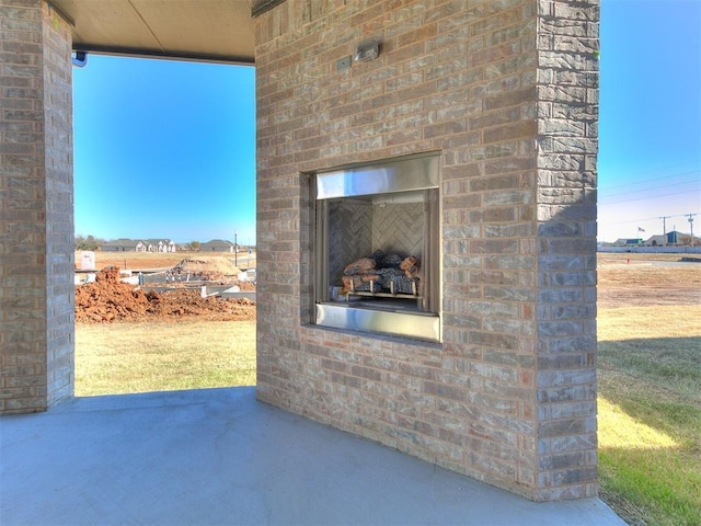 view of patio with an outdoor fireplace