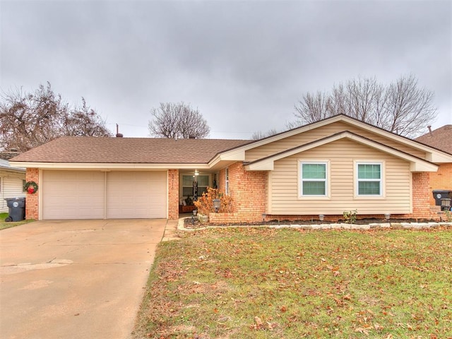 ranch-style house featuring a front yard and a garage