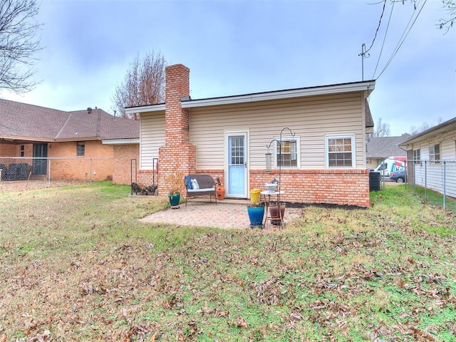 rear view of house featuring a patio area and a lawn