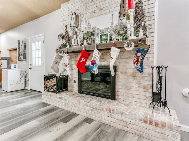 details featuring hardwood / wood-style flooring, a textured ceiling, and washer / clothes dryer