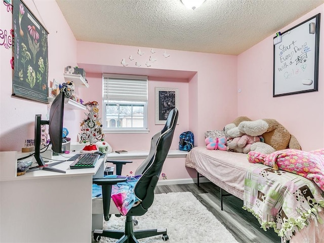 bedroom featuring hardwood / wood-style floors and a textured ceiling